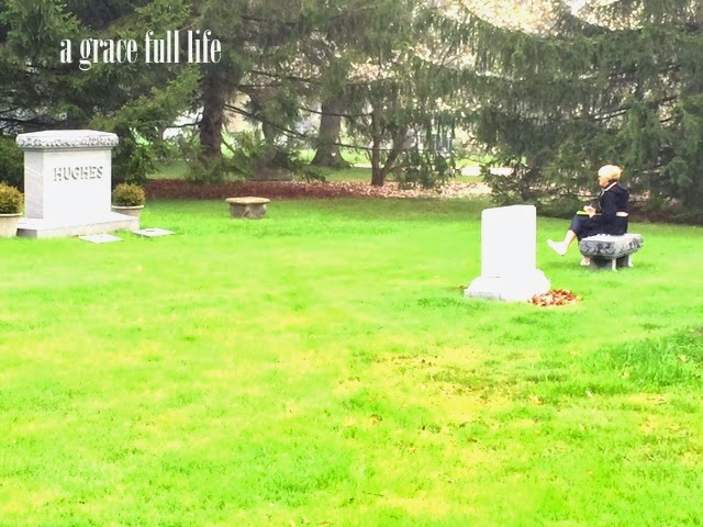 writer sitting at John Hughes grave site 
